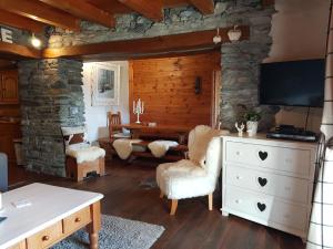 a living room with a stone wall at Chalet d'Heïdi in Bourg-Saint-Maurice +25 photos
