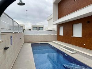 a swimming pool on the side of a building at Casa Bos Flamingo Pool and Jacuzzi in Puerto Marino