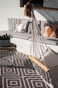 a hammock hanging on a couch in a living room at Casa-Simplicity 