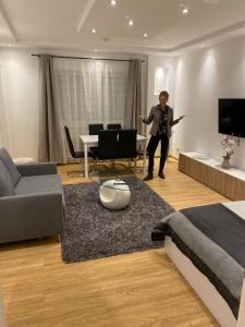 a woman is standing in a living room at Gracja Apartment in Berlin