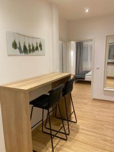 a kitchen with a desk and two chairs in a room at Gracja Apartment in Berlin