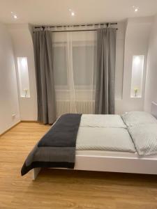 a white bed in a room with a window at Gracja Apartment in Berlin