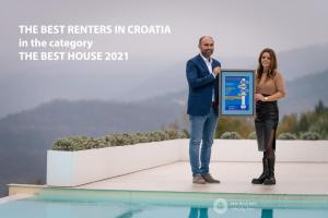 a man and a woman standing on a stage with a tablet at Villa with Private Pool & Lake View near Motovun, Casa Mille Olivi Heritage in Buzet +62 photos