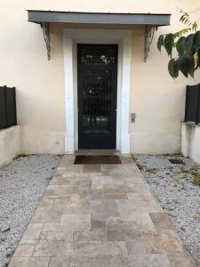 a black door on the side of a building at La Villa Soregia in Lattes