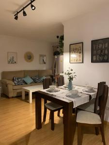 uma mesa de jantar e cadeiras numa sala de estar em Ponte Canedo em Ourense