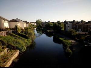 a view of a river in a city with houses at The Staithe by the Canal. in Lancaster