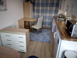 a kitchen with a table and a table and a sink at The Staithe by the Canal. in Lancaster