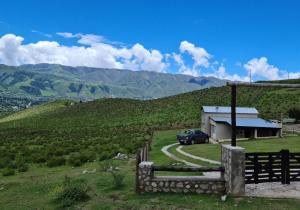 a car parked in front of a building on a hill at Hermosa casa en Tafí del Valle! in Tafí del Valle