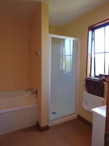 a bathroom with a shower and a tub and a sink at 30 St James Avenue in Hanmer Springs