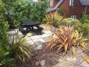 a picnic table in a garden with plants at 30 St James Avenue in Hanmer Springs