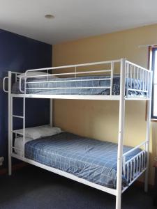 two bunk beds in a room with a bed at 30 St James Avenue in Hanmer Springs