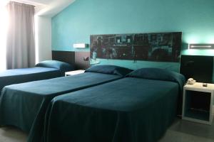 Un pat sau paturi într-o cameră la Hotel Mondial