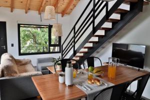 a dining room with a wooden table and stairs at Espino Blanco Apartamentos in San Carlos de Bariloche