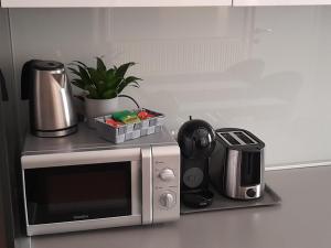 a kitchen counter with a microwave and a coffee maker at La Dolce Vita Zagreb, Centrally located & Spacious in Zagreb