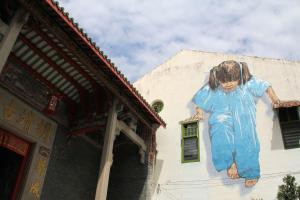 a large painting of a woman on the side of a building at MoonTree47 in George Town