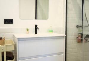 a white bathroom with a sink and a shower at BRAND NEW & BEST LOCATION!!! SPOTLESS APARTMENT in Sant Feliu de Guíxols