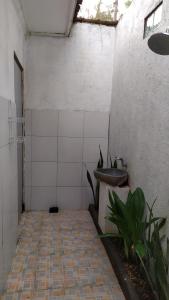 a bathroom with a sink and a tiled floor at Chemel Homestay in Kuta Lombok