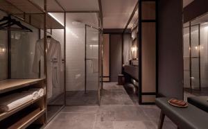 a bathroom with a shower and a walk in shower at Alila Bangsar Kuala Lumpur in Kuala Lumpur