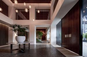 a hallway with a table and a vase on it at Alila Bangsar Kuala Lumpur in Kuala Lumpur