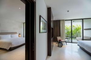 a bedroom with a bed and a view of a room at Studios at Alila Seminyak in Seminyak