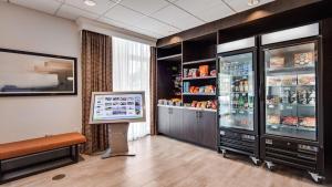 a waiting room with a refrigerator and a tv at Best Western Plus Hershey in Hershey