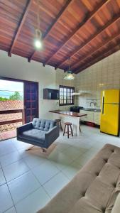 a large living room with a couch and a kitchen at Kitnet Superior com Vista para o Mar in São Sebastião
