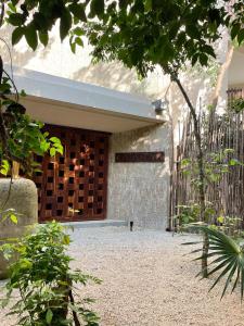 a entrance to a building with a door at Kataleya Tulum by Zaazil - New Luxury Penthouse Up to 10 people, 3-level, 3240 sqft , Private Pool, Terrace and Roof Top in Luum Zama in the Jungle in Tulum +30 photos