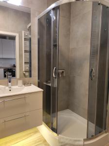 a bathroom with a shower and a sink at Sweet Apartment vis-a-vis Medicover and Paley Institute in Warsaw