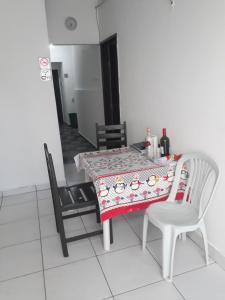 a dining room table with a table cloth and two chairs at HOTEL LATINOS 2 in Boa Vista