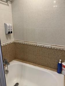 a bath tub in a bathroom with a sink at Sea View Holiday House in Hong Kong