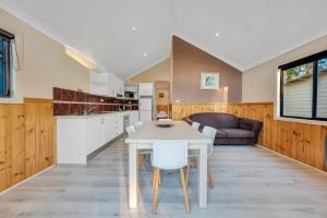 a kitchen and dining room with a white table and chairs at Ingenia Holidays Avina in Vineyard