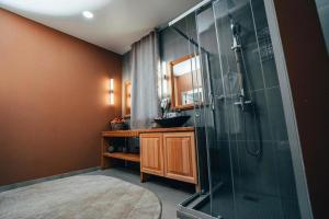 a bathroom with a glass shower and a sink at Алаас in Yakutsk