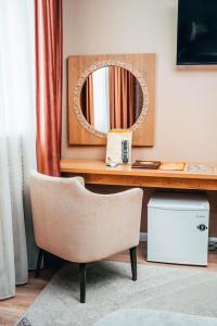 a desk with a chair in front of a mirror at Алаас in Yakutsk