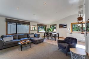 a living room with a couch and a table at Remarkables View in Queenstown