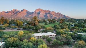 an aerial view of a town with mountains in the background at @TucsonMuralHouse w/pool & hot tub on golf course in Oro Valley