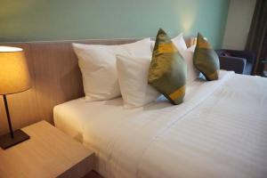 
เตียงในห้องที่ Tamarind Garden Hotel - SHA Plus Certified
