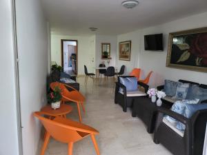 a living room with couches and chairs and a table at PATUCA C4 in Santa Marta