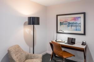 a room with a desk with a laptop and a chair at Meriton Suites North Sydney in Sydney