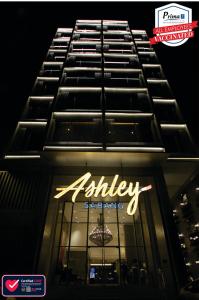 a lit up sign on the side of a building at Ashley Sabang Jakarta in Jakarta
