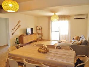 a living room with a table and chairs at Villa Sunset in La Saline les Bains