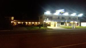 a building with lights on top of it at night at Cardwell at the Beach in Cardwell