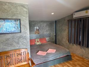 a bedroom with a large bed in a room at Khao Kho Copter Hill in Ban Khao Ya Nua