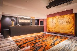 a lobby with a large wall with a tiger mural at Amory Hotel by Hyllit in Antwerp