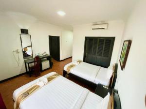 Postel nebo postele na pokoji v ubytování Angkor Tiger Resort