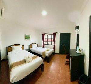 Postel nebo postele na pokoji v ubytování Angkor Tiger Resort