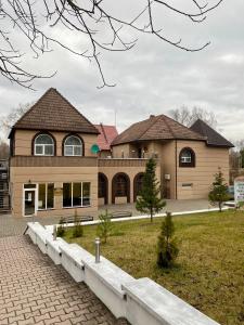 a large house with a walkway in front of it at Парк-Отель Миллениум in Zaokskiy