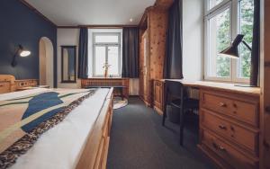 Postel nebo postele na pokoji v ubytování Hotel Davoserhof by Mountain Hotels