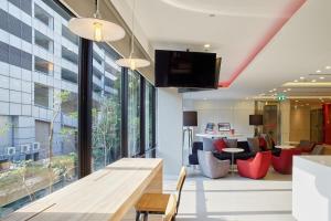an office lobby with a large window and a table at Red Planet Bangkok Surawong in Bangkok