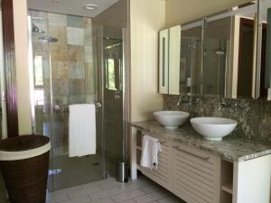 a bathroom with two sinks and a shower at Bigarade Suite by Simply-Seychelles in Eden Island