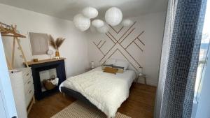 a bedroom with a bed and a fireplace at Le Grand Est Scandinave, centre ville, proche cathédrale in Reims